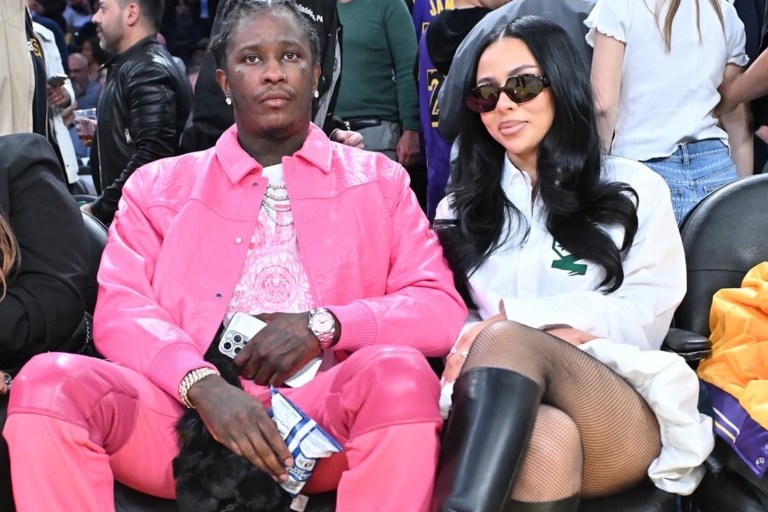 Mariah The Scientist Sits Courtside at Basketball Game with Young Thug Wearing a $740 Coperni Gathered Hem Shirt Dress and Amina Muaddi Boots