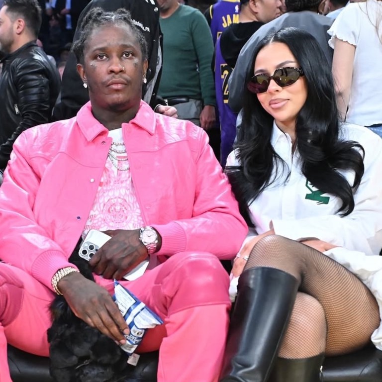 Mariah The Scientist Sits Courtside at Basketball Game with Young Thug Wearing a $740 Coperni Gathered Hem Shirt Dress and Amina Muaddi Boots