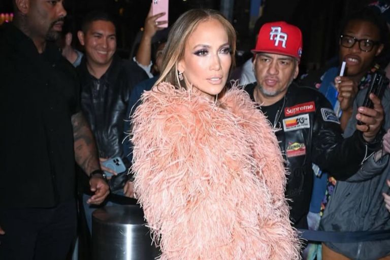 Jennifer Lopez Wore a Peach $835 “The New Arrival” Dress with a Feather Bolero and FEMME LA Heels to the Ring Them Bells benefit Concert in New York