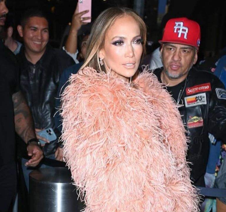 Jennifer Lopez Wore a Peach $835 “The New Arrival” Dress with a Feather Bolero and FEMME LA Heels to the Ring Them Bells benefit Concert in New York
