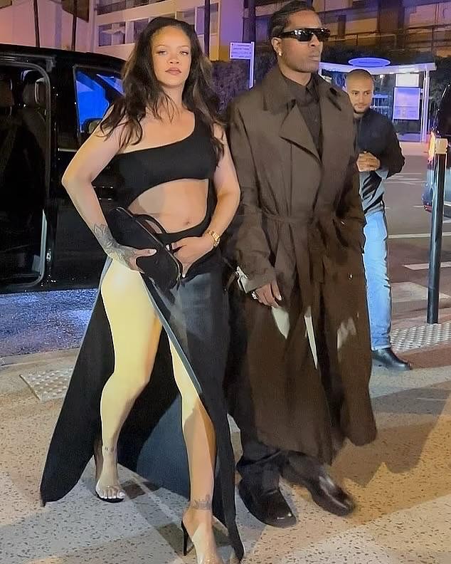 Rihanna Steps In A Black Cutout Alaia Maxi Dress With Beau AAP Rocky In A Brown Saint Laurent Trench Jacket In Cannes France 1