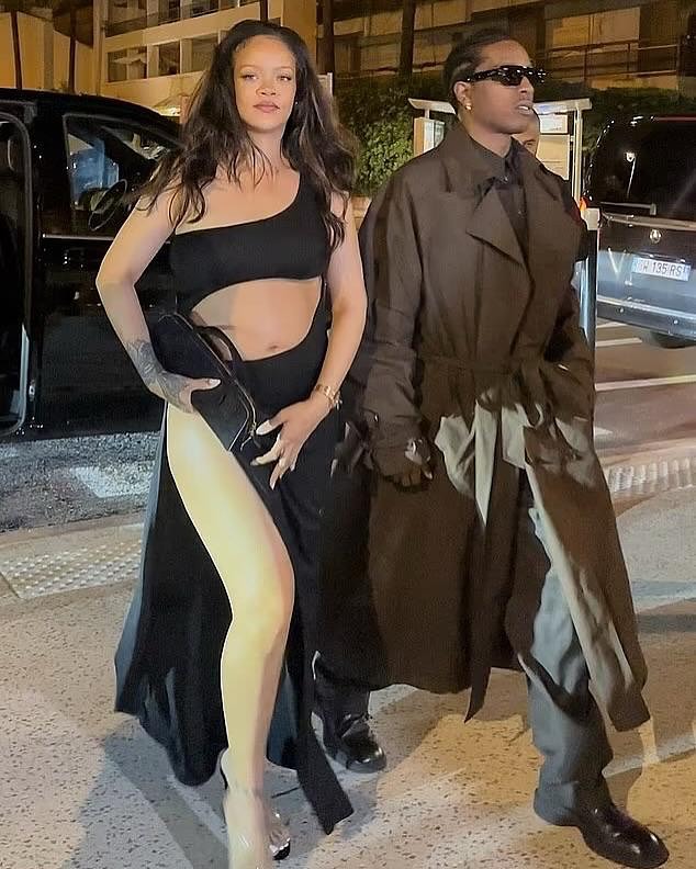 Rihanna Steps In A Black Cutout Alaia Maxi Dress With Beau AAP Rocky In A Brown Saint Laurent Trench Jacket In Cannes France 2