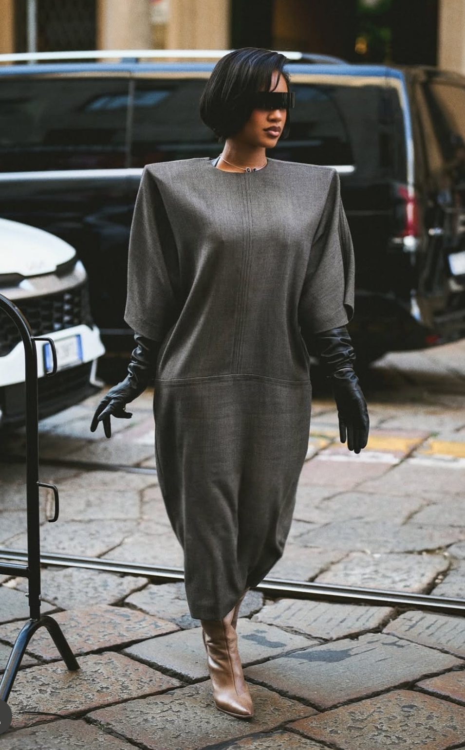 Milan Fashion Week Sweetie Attended The MM6 Maison Margiela Runway Show In A Gray Structured Dress With Black Gloves And Tan Boots 2
