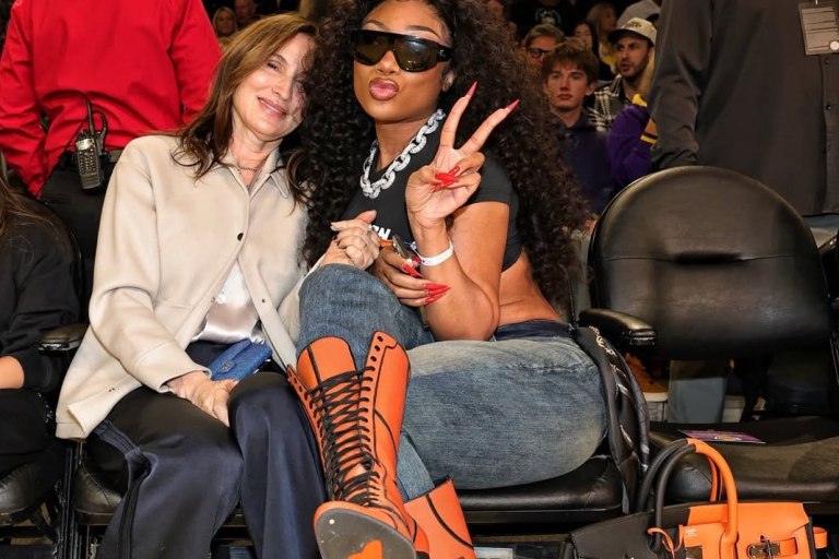 Megan Thee Stallion Courtside in Orange Lace-Up Heels and a Black-and-Feu Hermès Casaque HAC Bag at the Mavs vs. Lakers Game